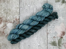 Load image into Gallery viewer, Silver Sparkle 4ply 50g in the In The Deep colourway with a coordinating mini skein