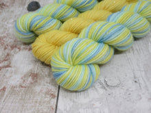 Load image into Gallery viewer, Silver Sparkle Self Striping Yarn in Life's A Beach colourway with a coordinating mini skein