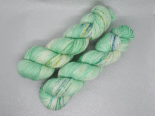 Load image into Gallery viewer, Gold Sparkle Sock Yarn 100g skein in Mistletoe Kisses Colourway