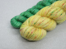 Load image into Gallery viewer, Silver Sparkle 4ply 50g in Jingle All The Way colourway with a Green Speckled mini skein