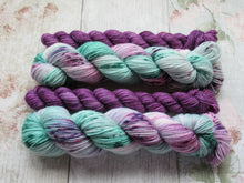 Load image into Gallery viewer, Silver Sparkle 4ply 50g in Sea Glass colourway with a purple speckled mini skein