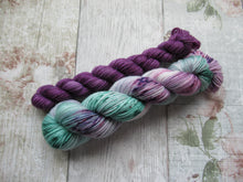 Load image into Gallery viewer, Silver Sparkle 4ply 50g in Sea Glass colourway with a purple speckled mini skein