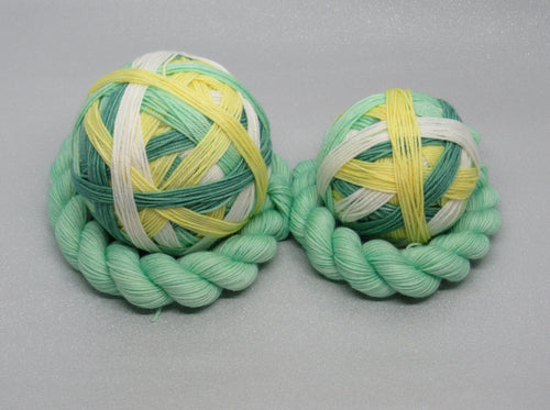 Deluxe Merino Nylon Self Striping Yarn in the Christmas Rose colourway with a coordinating mini skein
