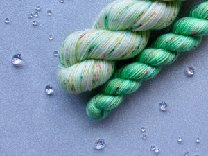 Silver Sparkle 4ply 50g in Christmas In July colourway Festive Speckles with a mini skein in Speckled Green