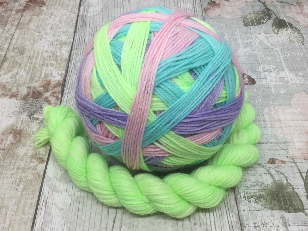 Deluxe Merino Nylon Self Striping Yarn in 'Feelings of Spring' colourway with a coordinating mini skein