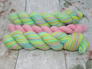 Silver Sparkle Self Striping Yarn in If You're Happy and You Know It colourway with a coordinating mini skein