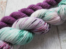 Load image into Gallery viewer, Deluxe Merino Nylon 4ply 50g in Sea Glass colourway with a purple speckled mini skein