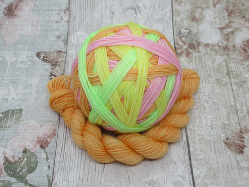 Deluxe Merino Nylon Self Striping Yarn in Lolly colourway with a coordinating mini skein