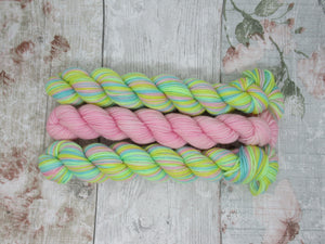 Silver Sparkle Self Striping Yarn in If You're Happy and You Know It colourway with a coordinating mini skein