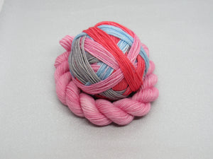 Deluxe Merino Nylon Self Striping Yarn in the Rocking Robin colourway with a coordinating mini skein