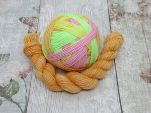 Deluxe Merino Nylon Self Striping Yarn in Lolly colourway with a coordinating mini skein